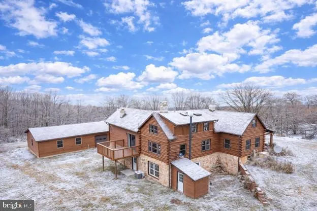 an aerial view of a house with swimming pool and sitting space