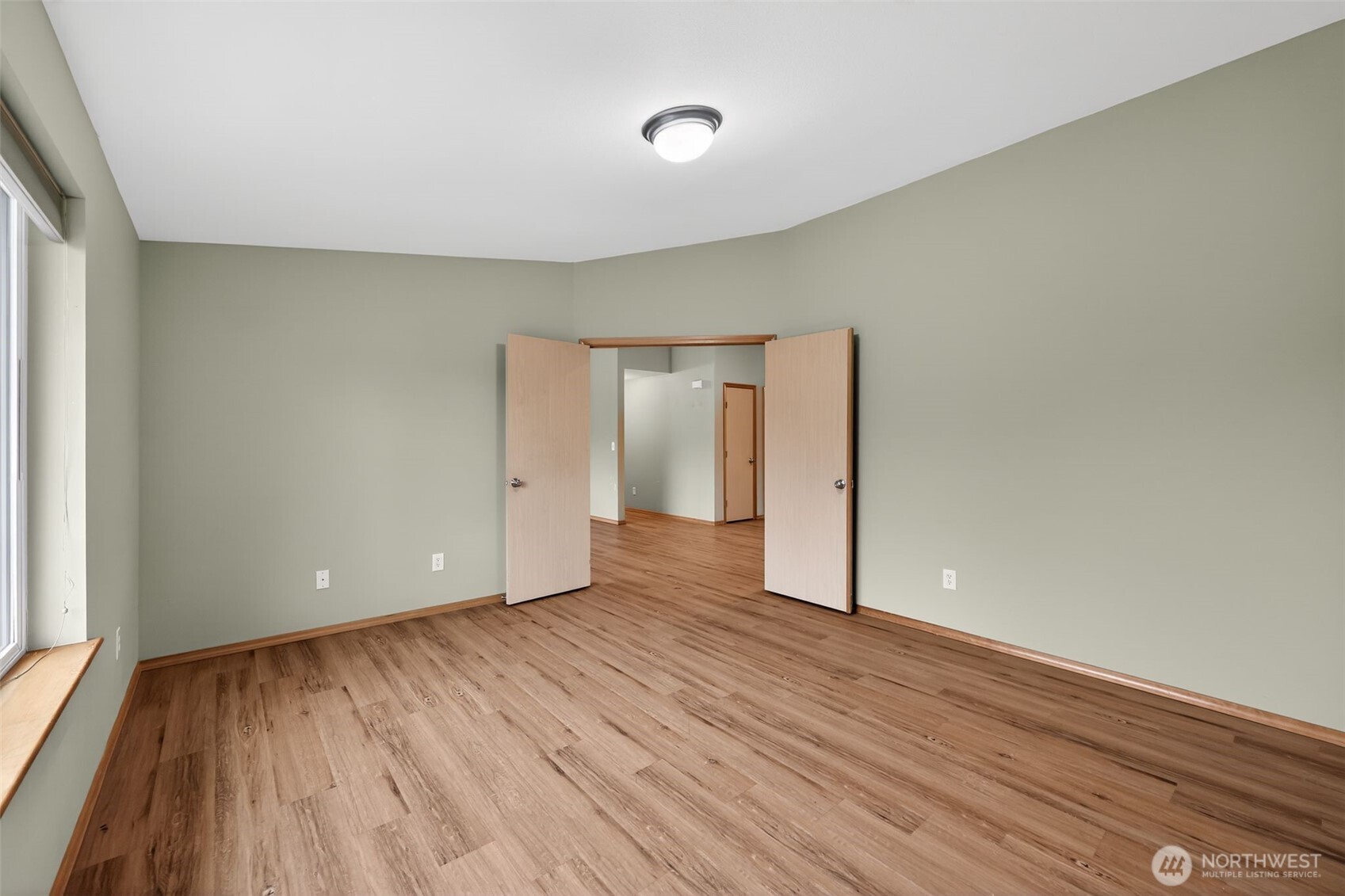 222 Oyler Road Ethel, WA 98542 - Photo 13 of 34 a view of an empty room with wooden floor and a window