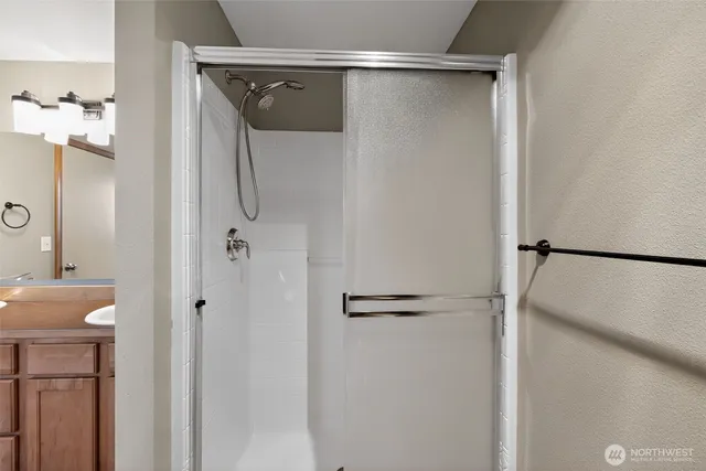 a bathroom with a glass shower door