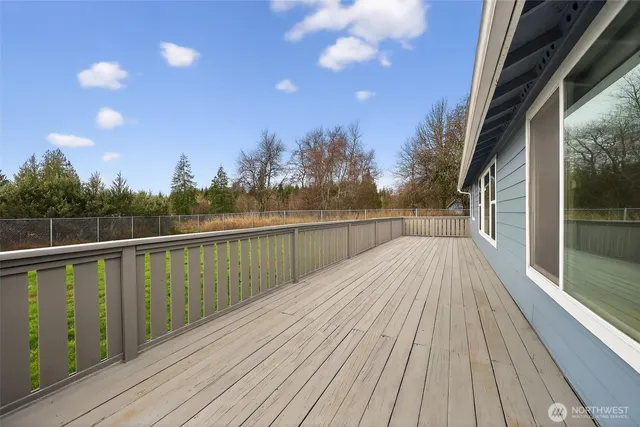 a view of balcony with wooden floor and fence