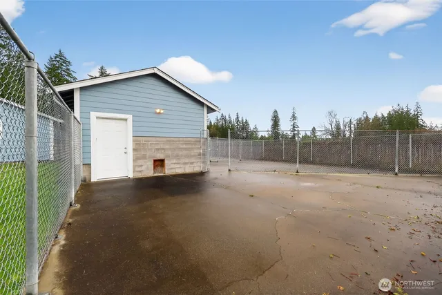 a aerial view of a house with swimming pool and large trees