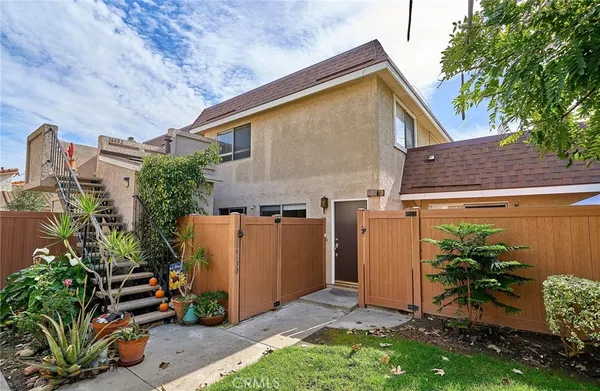 a view of a house with a yard and plants