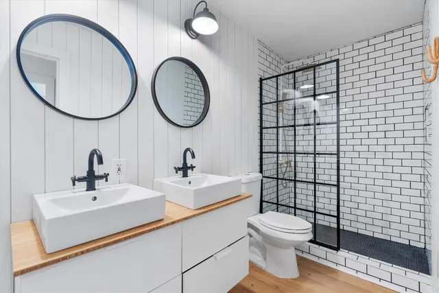 a bathroom with a toilet a sink and a mirror