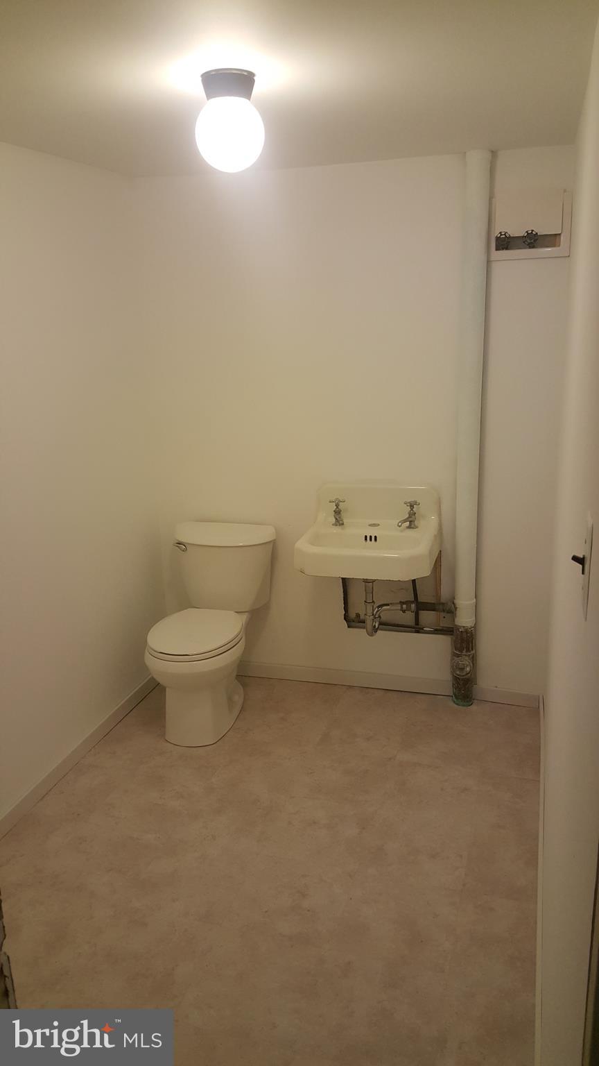 3428 Edcrest Road Baltimore, MD 21244 - Photo 15 of 19 a bathroom with a sink a toilet and a window