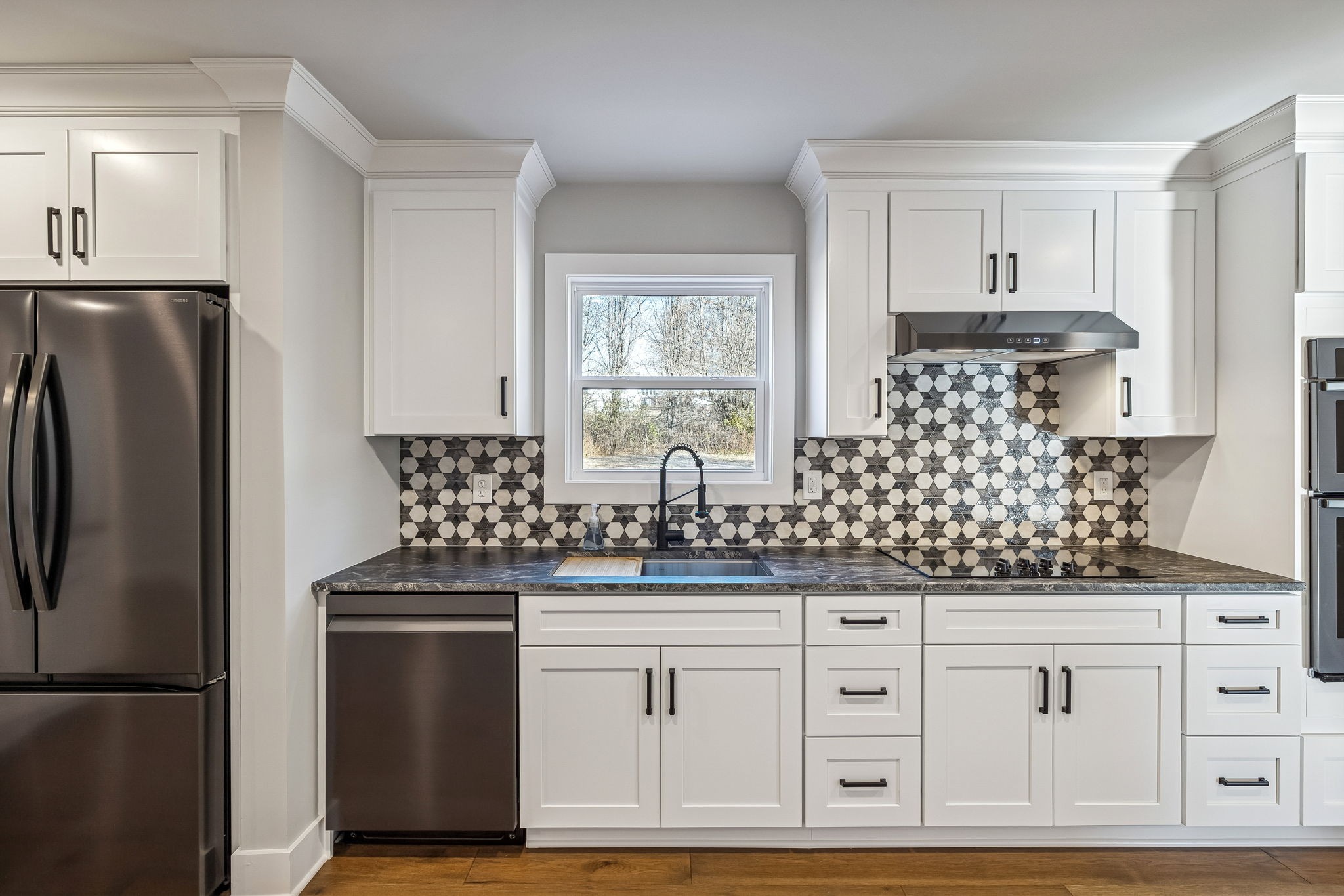 628 Vaughan's Gap Road Spring Hill, TN 37174 - Photo 12 of 45 a kitchen with stainless steel appliances granite countertop a refrigerator sink and cabinets