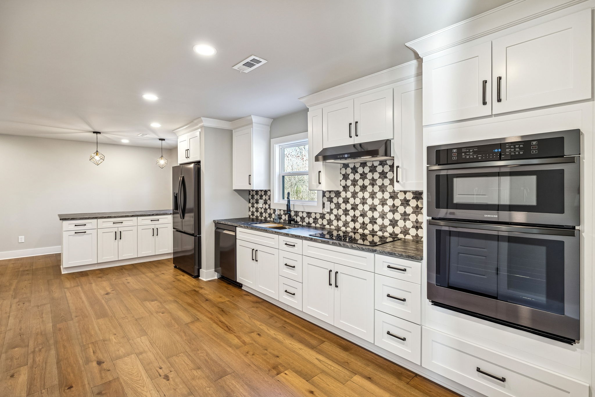 628 Vaughan's Gap Road Spring Hill, TN 37174 - Photo 13 of 45 a kitchen with granite countertop a refrigerator oven a sink dishwasher and white cabinets