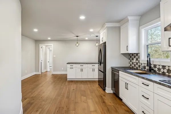a large kitchen with a lot of counter space and stainless steel appliances