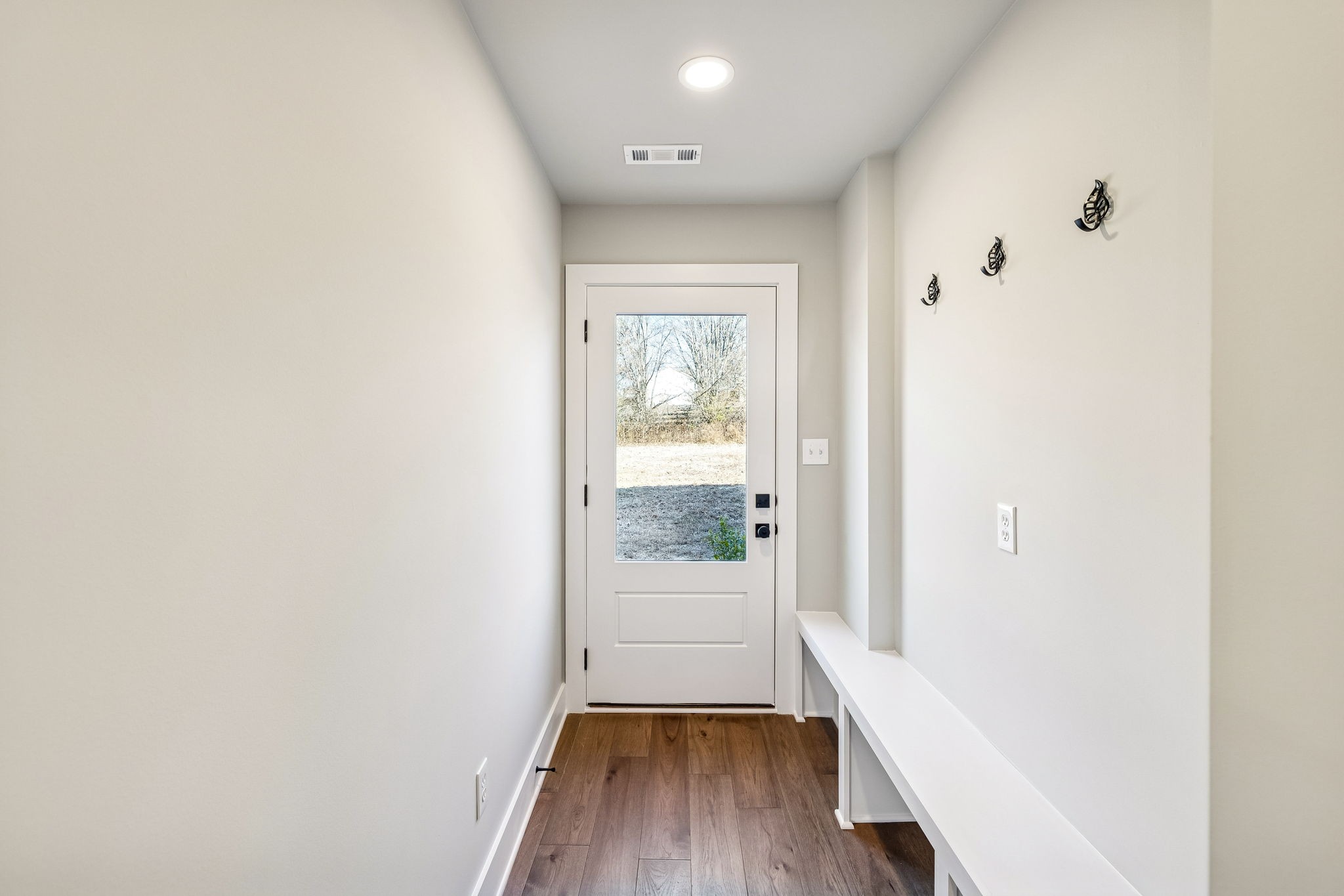 628 Vaughan's Gap Road Spring Hill, TN 37174 - Photo 16 of 45 a view of a hallway with wooden floor and a window