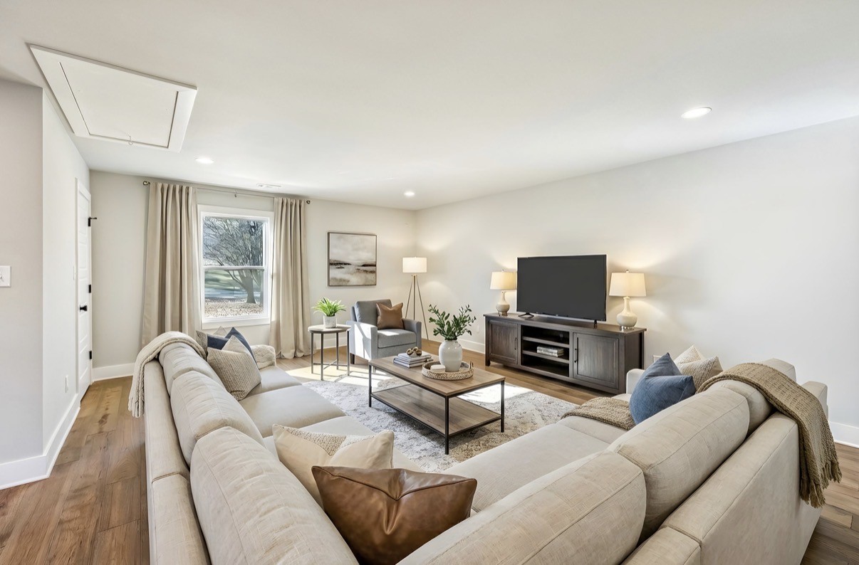 628 Vaughan's Gap Road Spring Hill, TN 37174 - Photo 18 of 45 a living room with furniture and a flat screen tv