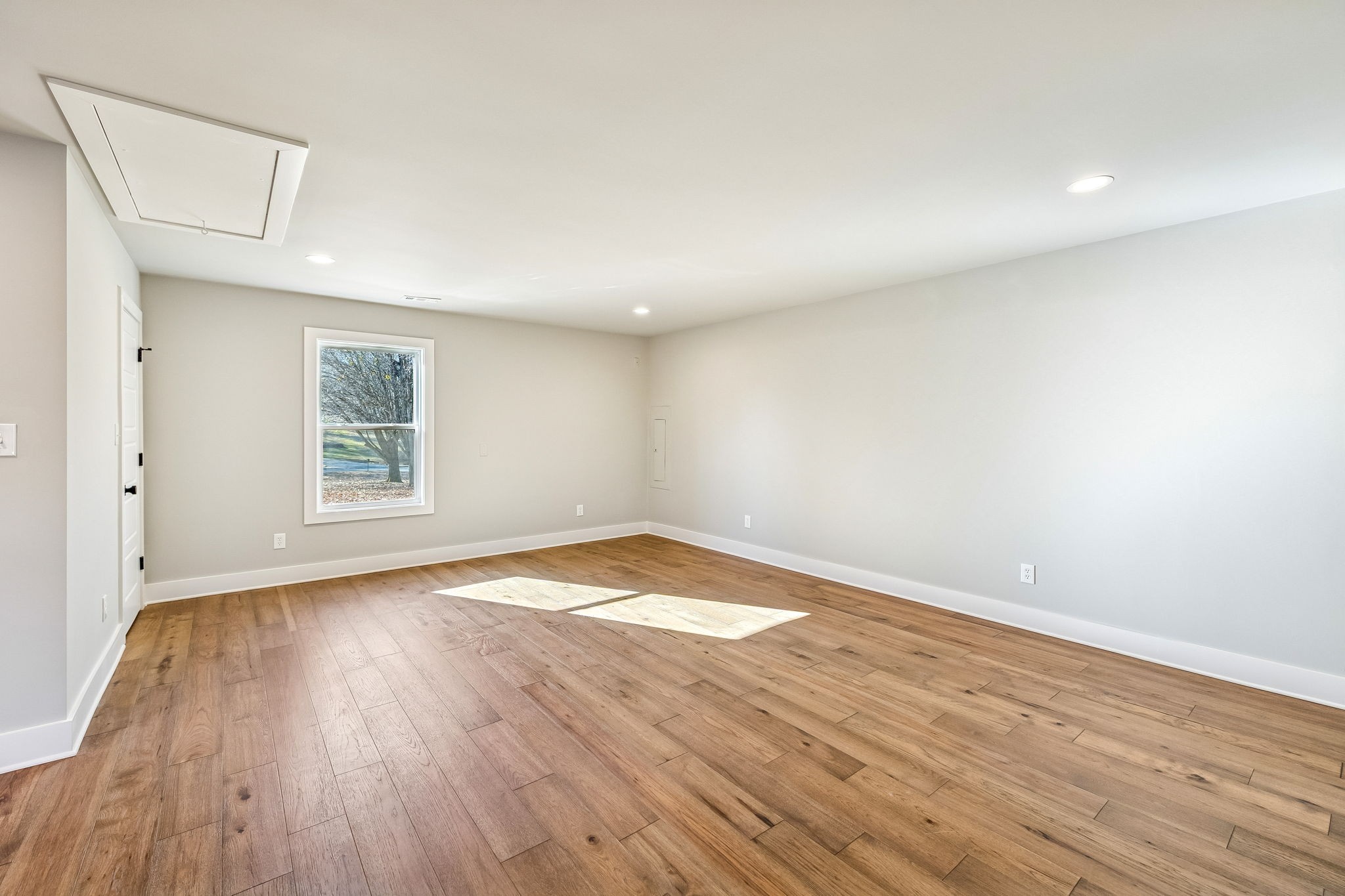 628 Vaughan's Gap Road Spring Hill, TN 37174 - Photo 19 of 45 an empty room with wooden floor and windows