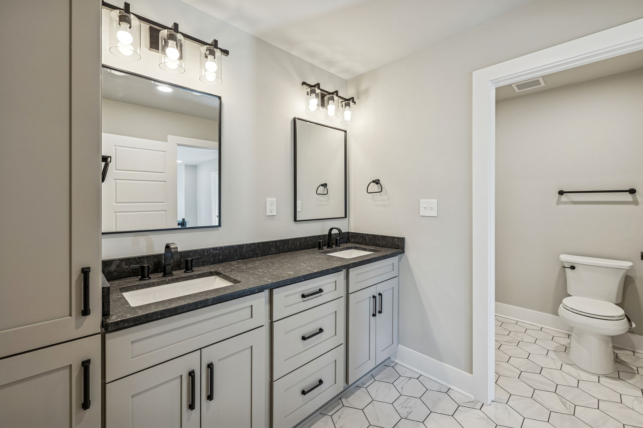 628 Vaughan's Gap Road Spring Hill, TN 37174 - Photo 30 of 45 a bathroom with a granite countertop sink a toilet and a mirror