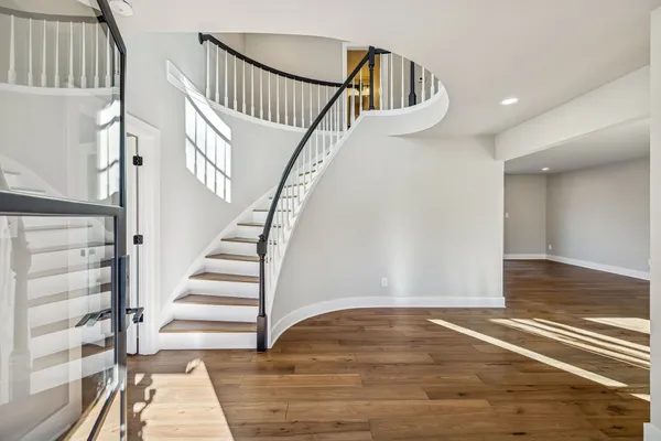 a view of entryway and hall with wooden floor