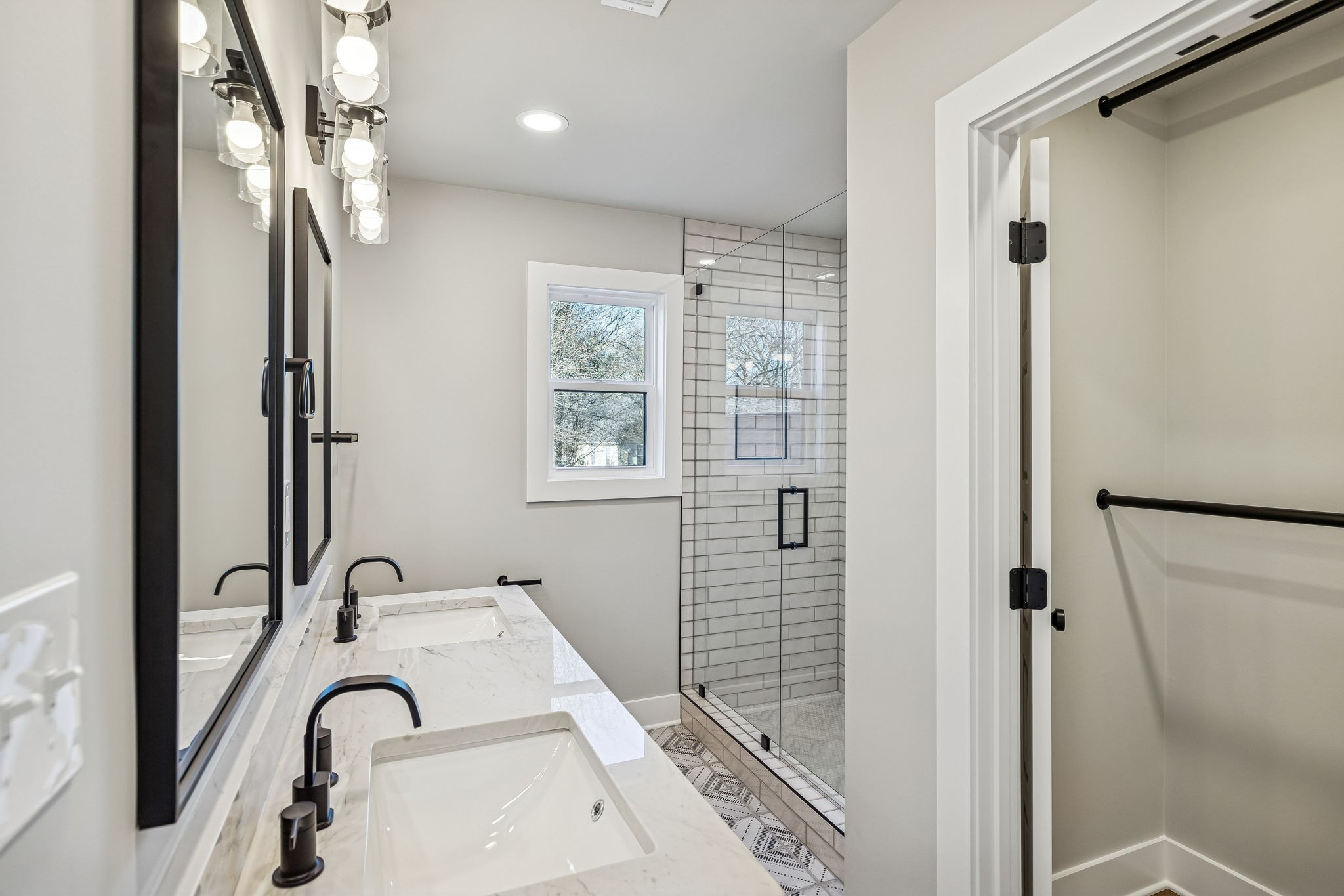 628 Vaughan's Gap Road Spring Hill, TN 37174 - Photo 36 of 45 a bathroom with a sink a mirror and a shower