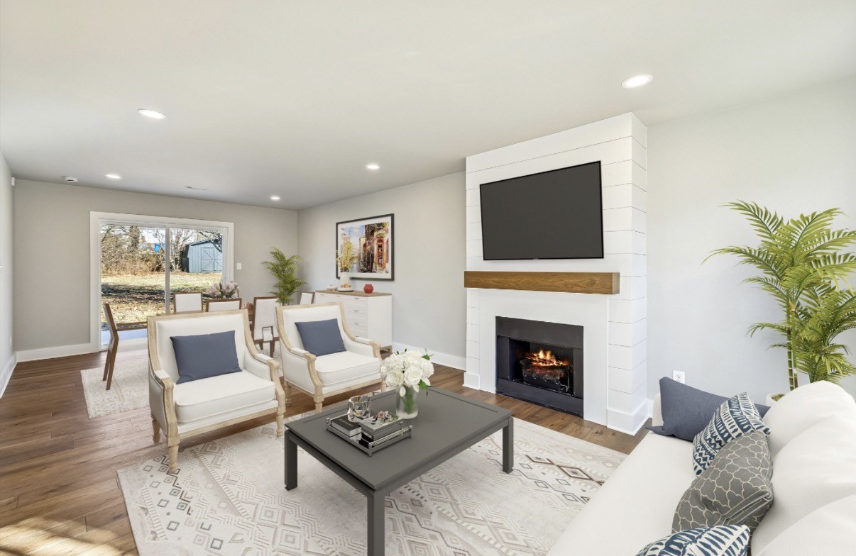 628 Vaughan's Gap Road Spring Hill, TN 37174 - Photo 9 of 45 a living room with furniture a fireplace and a flat screen tv