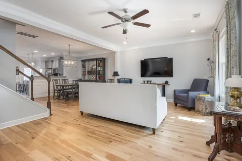 a dining room with furniture and wooden floor