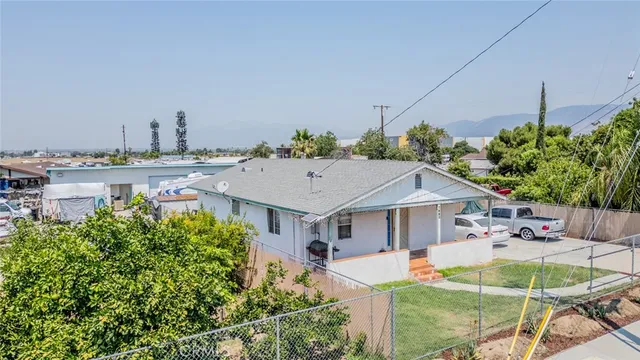 a aerial view of a house with table and chairs under an umbrella