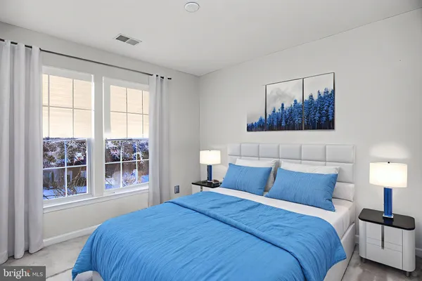 a bedroom with a large bed and a window