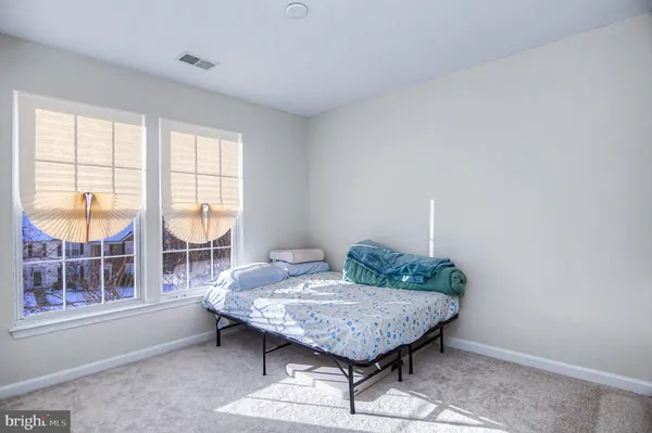 a view of a bedroom with furniture and window