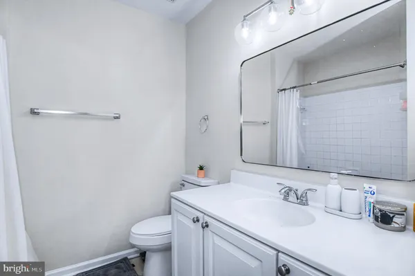 a bathroom with a sink toilet vanity and shower