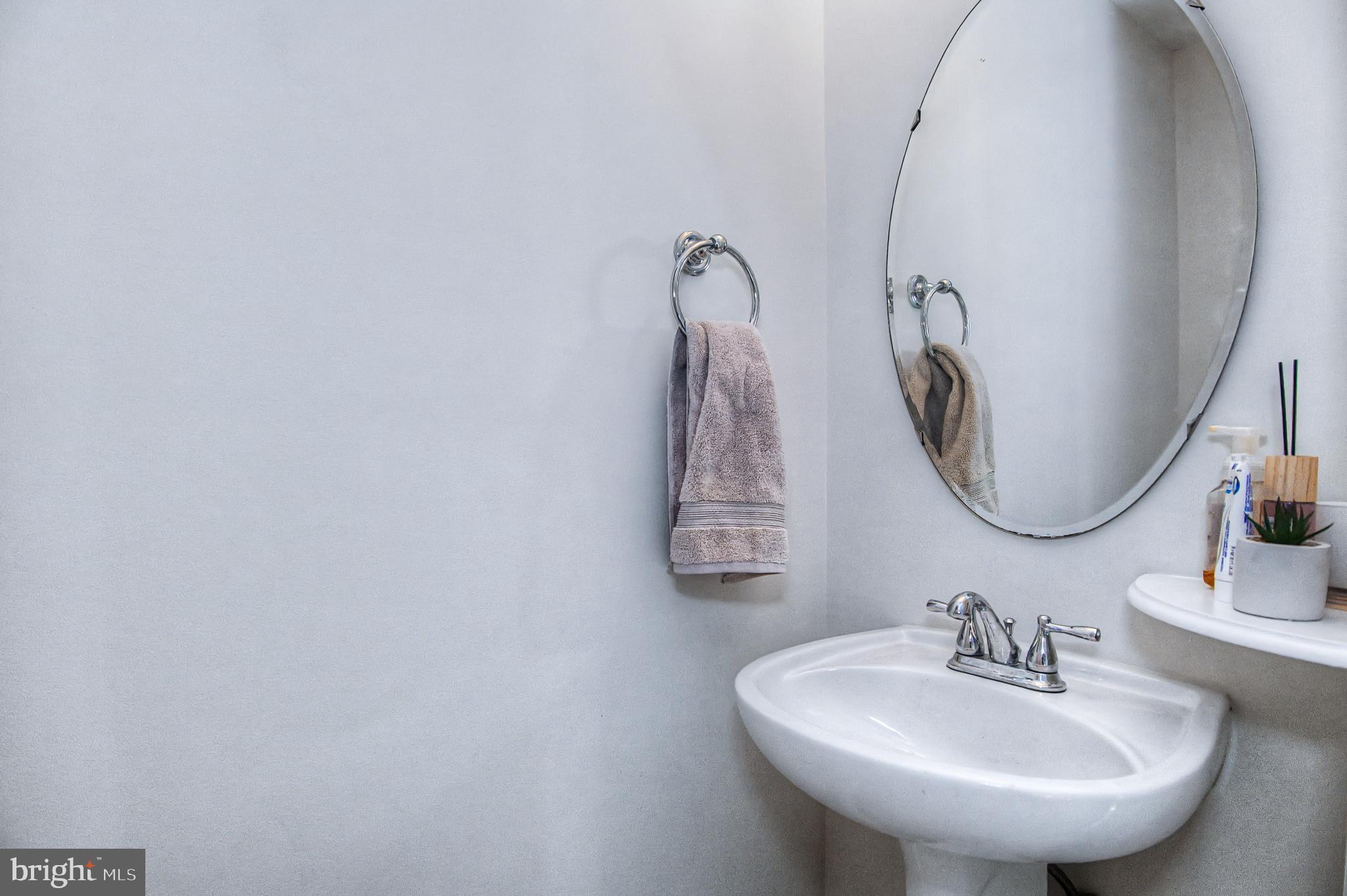 10159 Elgin Way Bristow, VA 20136 - Photo 34 of 41 a bathroom with a sink and a mirror