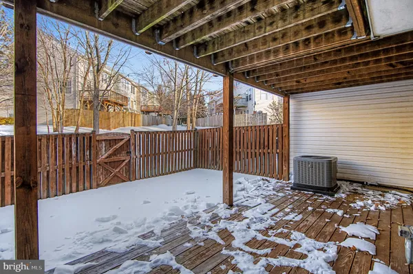 a view of a backyard with wooden fence