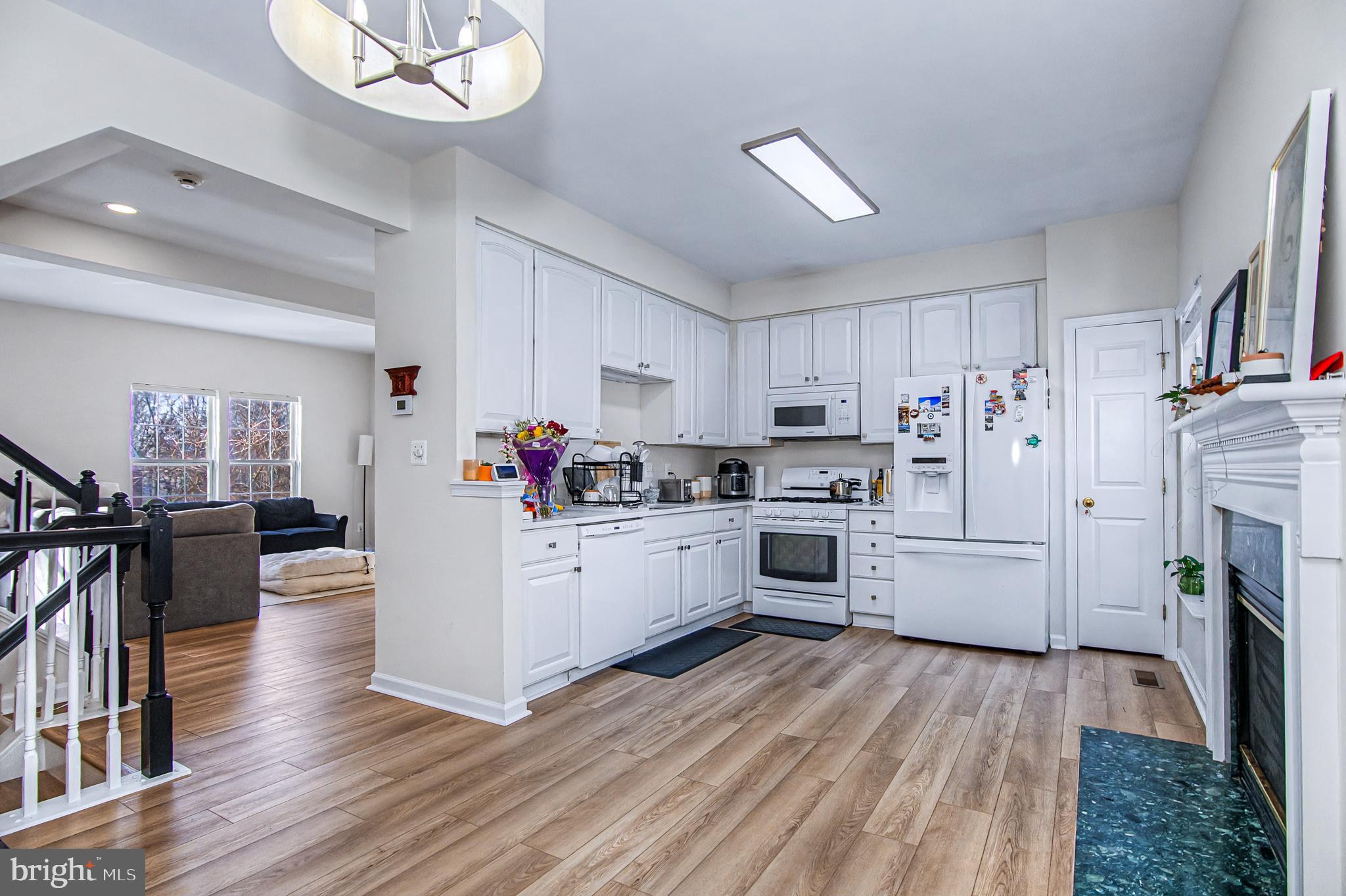 10159 Elgin Way Bristow, VA 20136 - Photo 4 of 41 a kitchen with white cabinets and white appliances