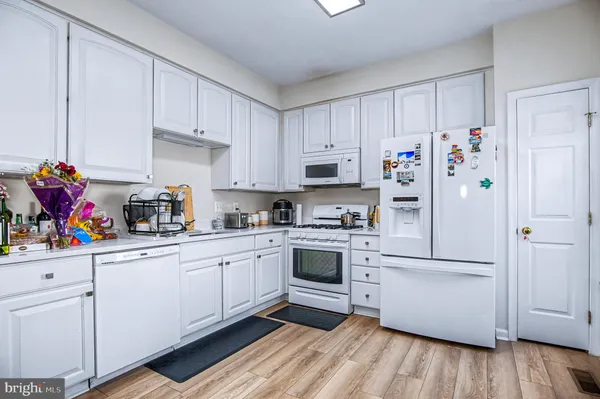 a kitchen with stainless steel appliances a refrigerator sink and cabinets