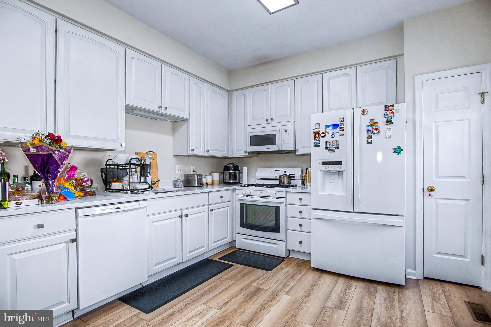 10159 Elgin Way Bristow, VA 20136 - Photo 5 of 41 a kitchen with stainless steel appliances a refrigerator sink and cabinets