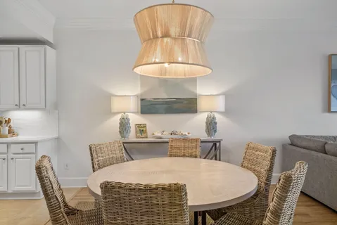 a kitchen that has a dining table and chairs