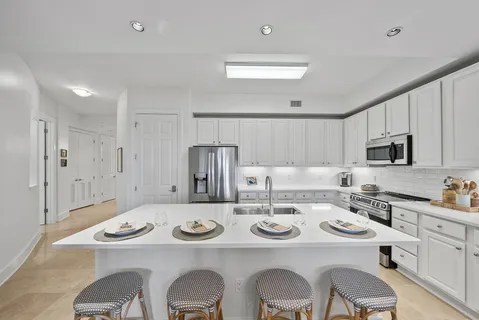 a dining room with furniture a chandelier and window