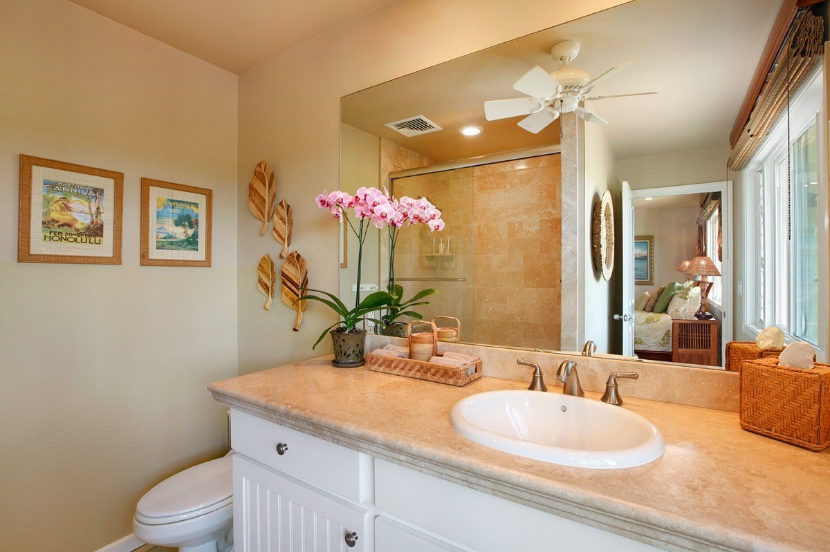 4820 Lawai Road Koloa, HI 96756 - Photo 20 of 27 a bathroom with a granite countertop sink mirror vanity and toilet