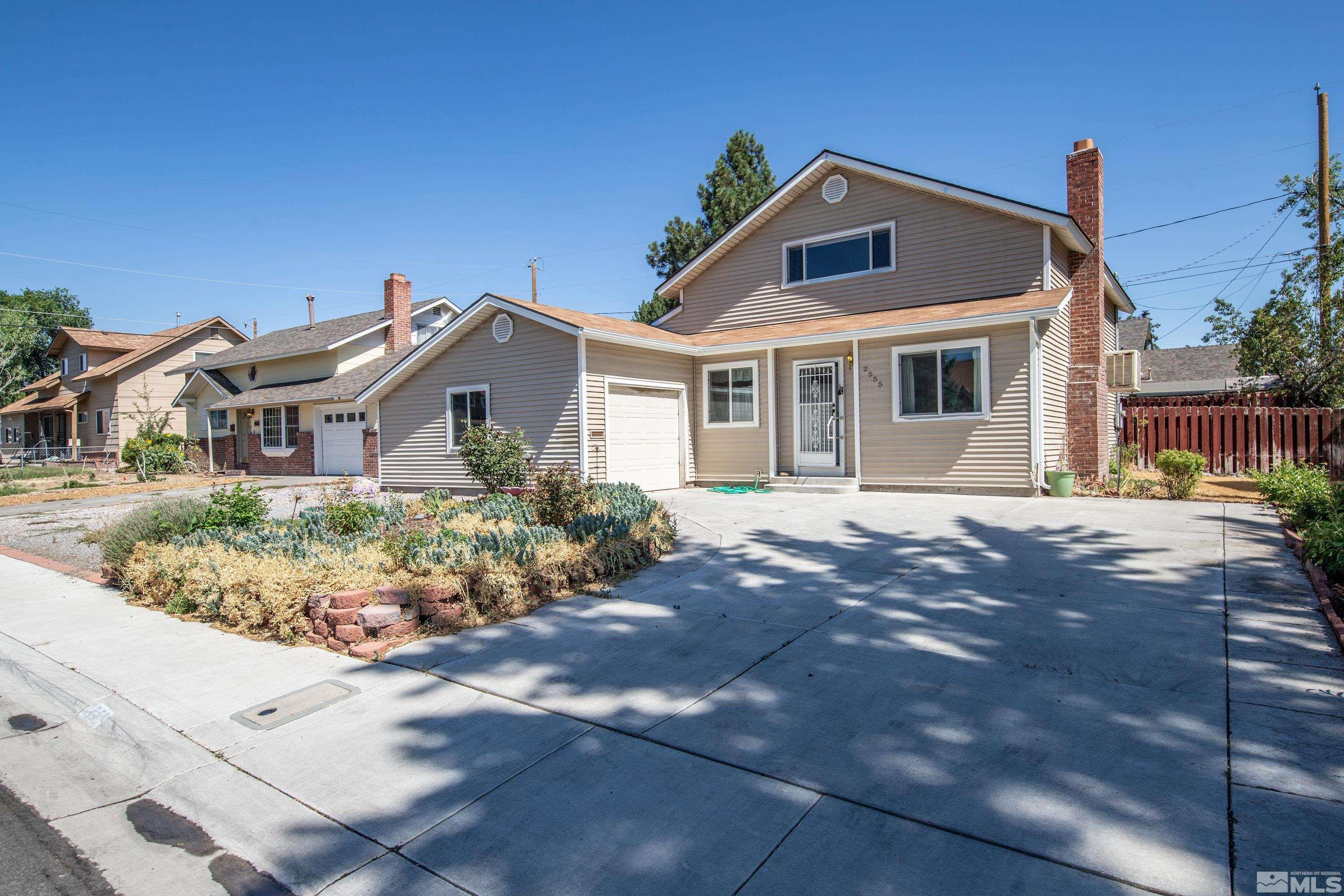 2555 Dyer Way Reno, NV 89512 - Photo 15 of 18 a front view of a house with a garden