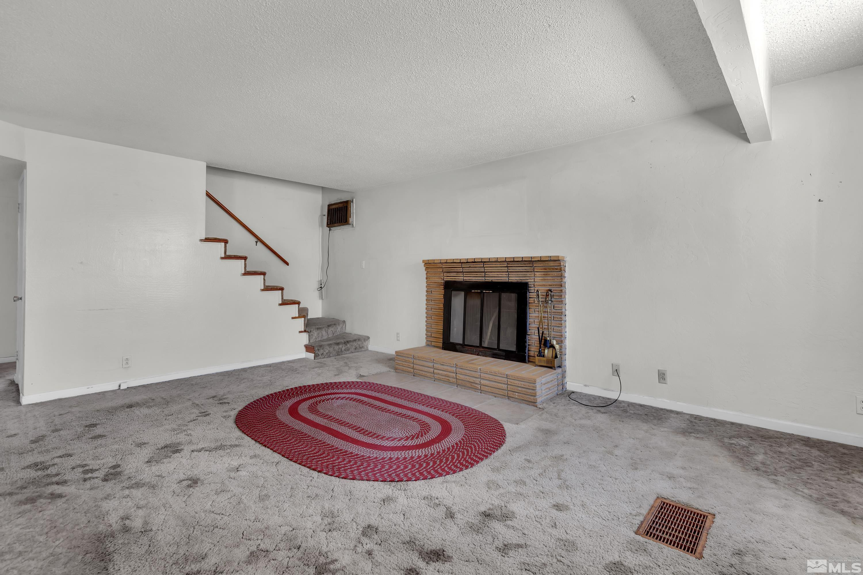 2555 Dyer Way Reno, NV 89512 - Photo 6 of 18 a view of a livingroom with wooden floor and a fireplace