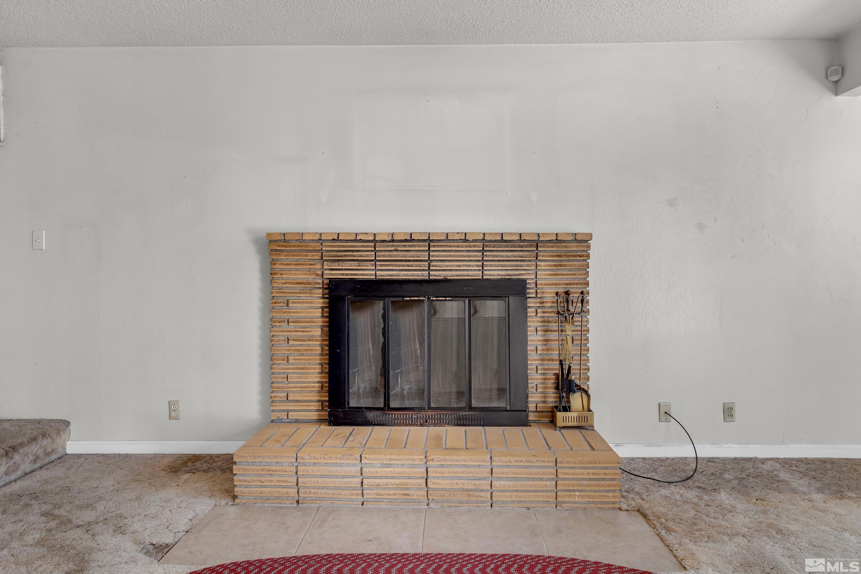 2555 Dyer Way Reno, NV 89512 - Photo 7 of 18 a living room with a fireplace