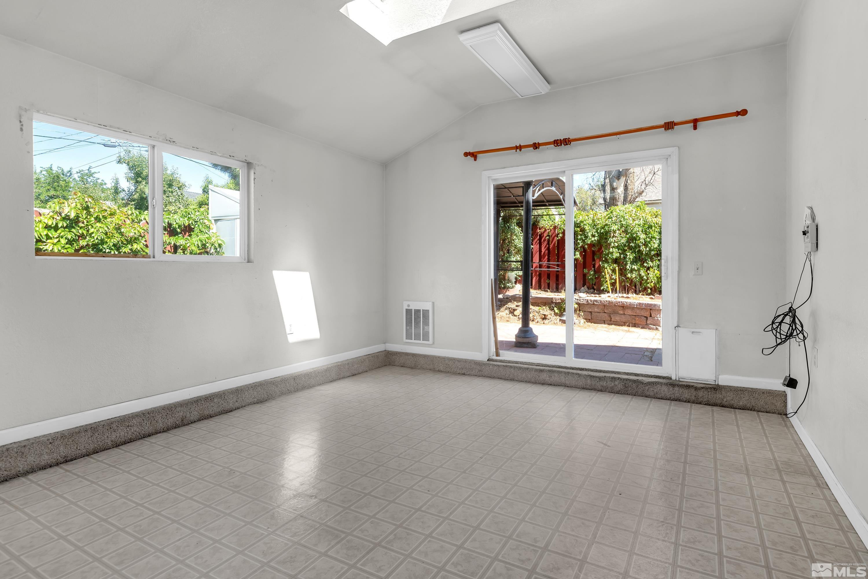 2555 Dyer Way Reno, NV 89512 - Photo 9 of 18 a view of a big room with wooden floor a fireplace and windows