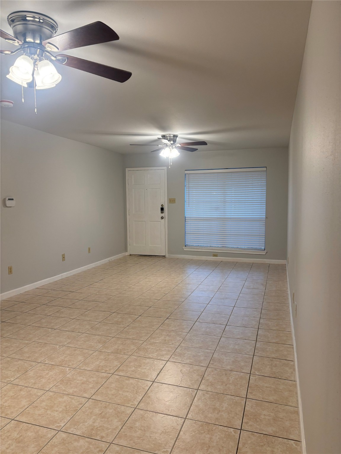 14333 Memorial Drive, Unit 39 Houston, TX 77079 - Photo 3 of 20 a view of an empty room with a chandelier fan