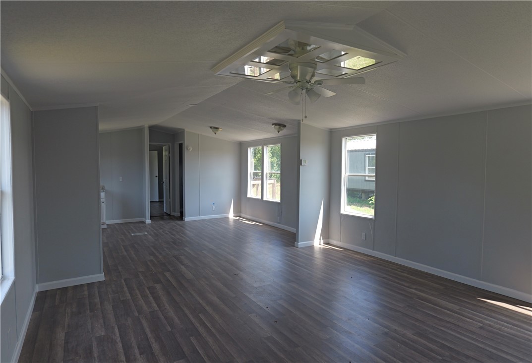 732 D Rogers Street Normangee, TX 77871 - Photo 3 of 12 a view of an empty room with wooden floor and a window
