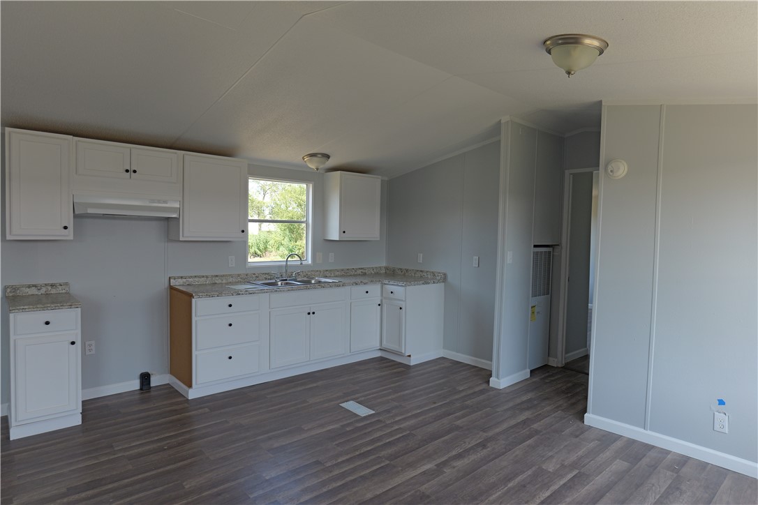 732 D Rogers Street Normangee, TX 77871 - Photo 4 of 12 an empty room with wooden floor and window