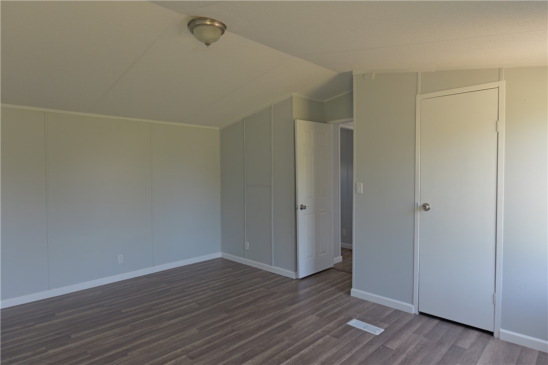 732 D Rogers Street Normangee, TX 77871 - Photo 6 of 12 a view of an empty room with wooden floor