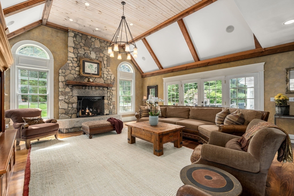 3 Stone Bridge Lane Milton, MA 02186 - Photo 18 of 37 a living room with furniture a fireplace and a floor to ceiling window