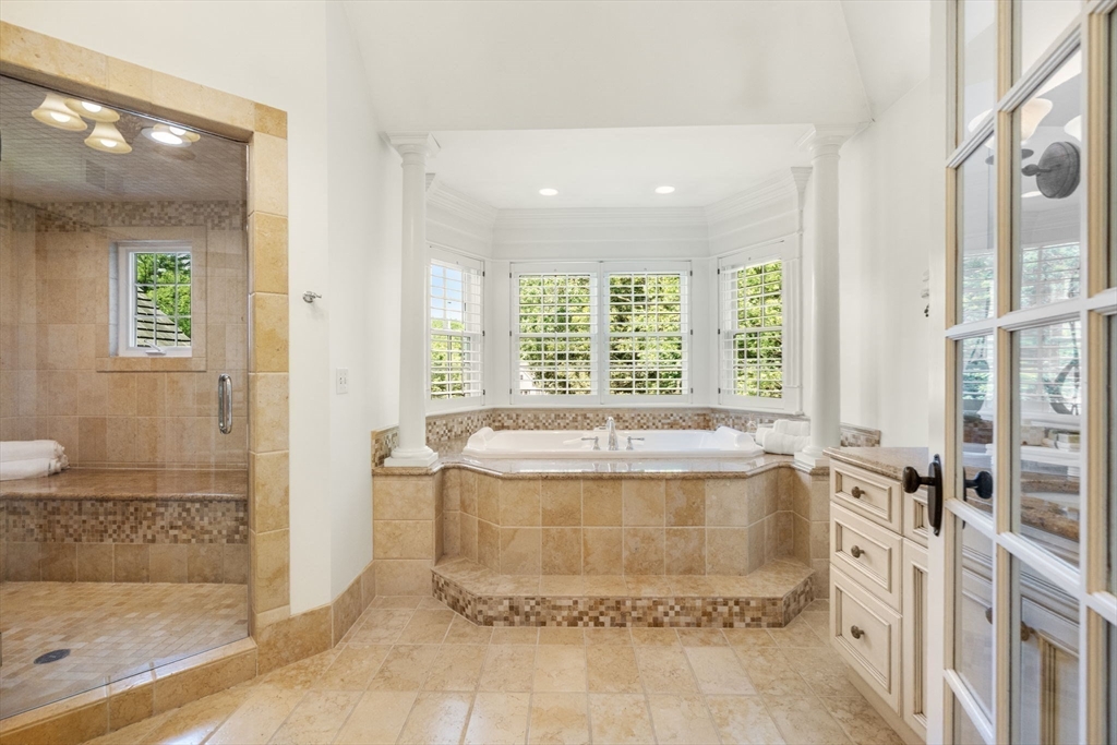 3 Stone Bridge Lane Milton, MA 02186 - Photo 21 of 37 a bathroom with a tub shower and window