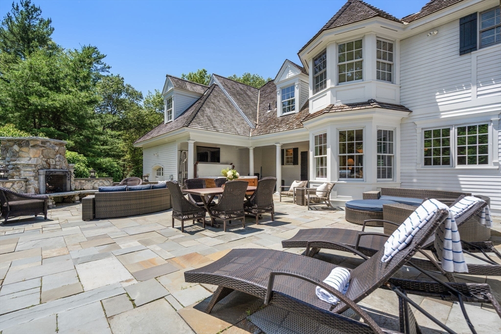 3 Stone Bridge Lane Milton, MA 02186 - Photo 30 of 37 a view of a patio with couches table and chairs and potted plants