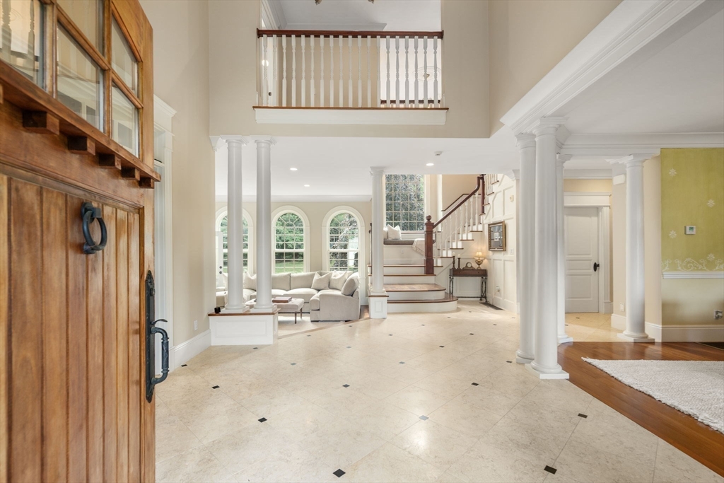 3 Stone Bridge Lane Milton, MA 02186 - Photo 6 of 37 a view of a hallway with wooden floor and living room
