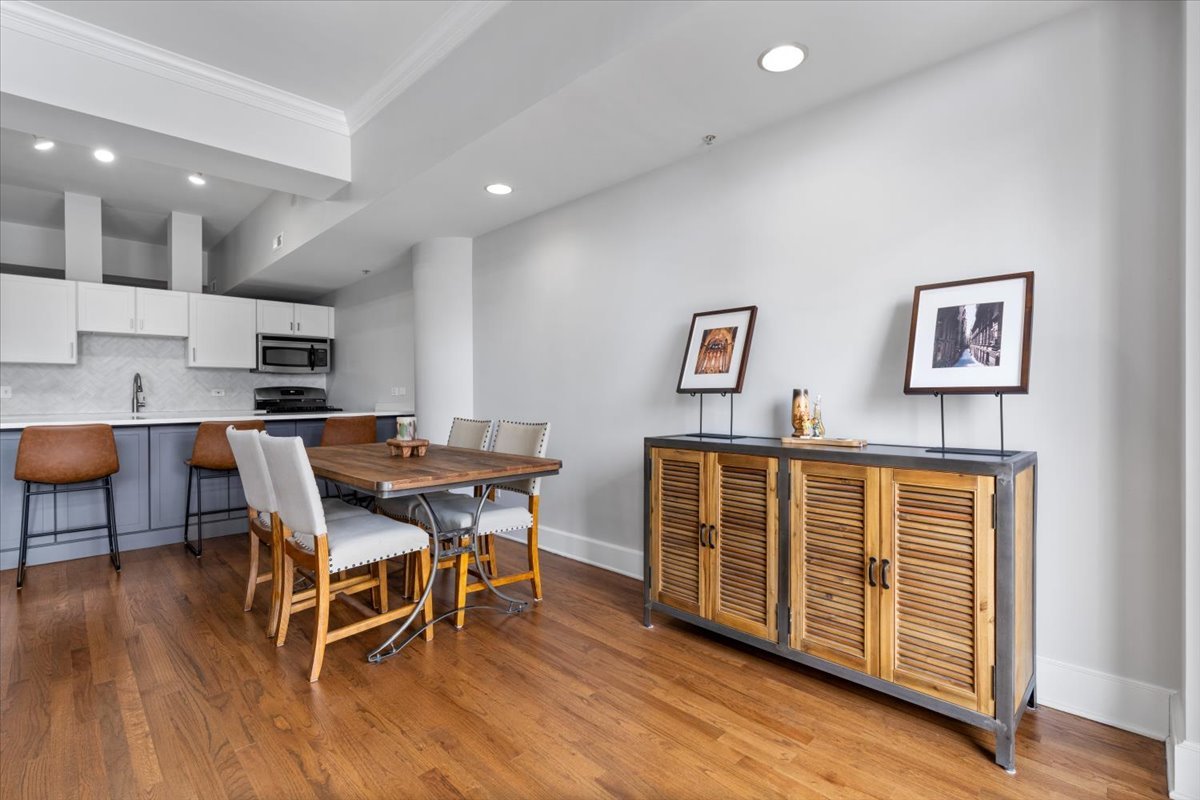 165 North Canal Street, Unit 706 Chicago, IL 60606 - Photo 12 of 27 a view of a dining room with furniture and wooden floor