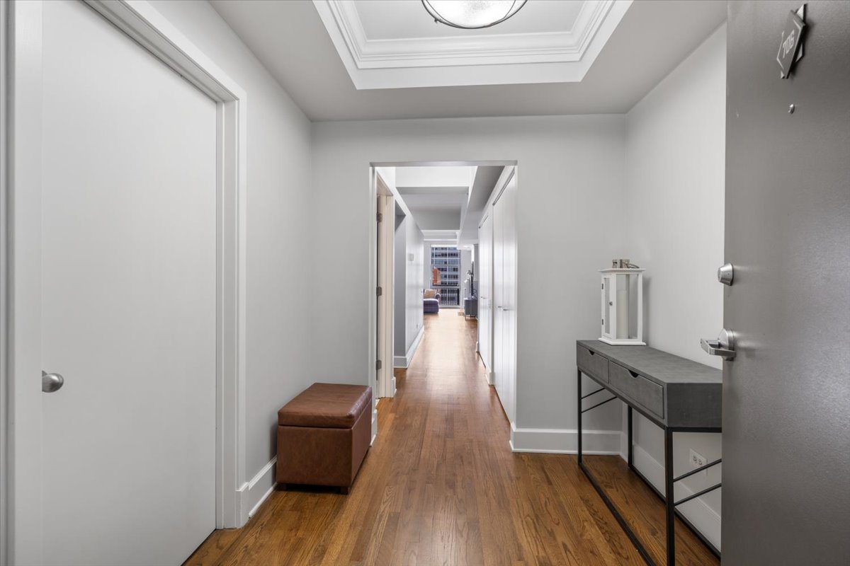 165 North Canal Street, Unit 706 Chicago, IL 60606 - Photo 2 of 27 a view of a hallway with wooden floor and a bathroom
