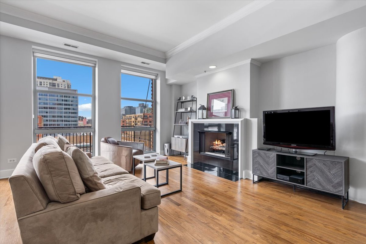 165 North Canal Street, Unit 706 Chicago, IL 60606 - Photo 8 of 27 a living room with furniture and a flat screen tv