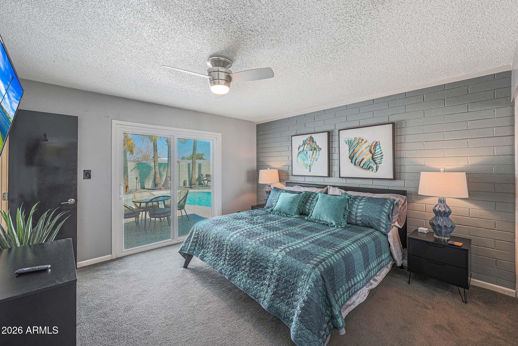 2201 East Marilyn Road Phoenix, AZ 85022 - Photo 28 of 47 a bedroom with a large bed and a chandelier