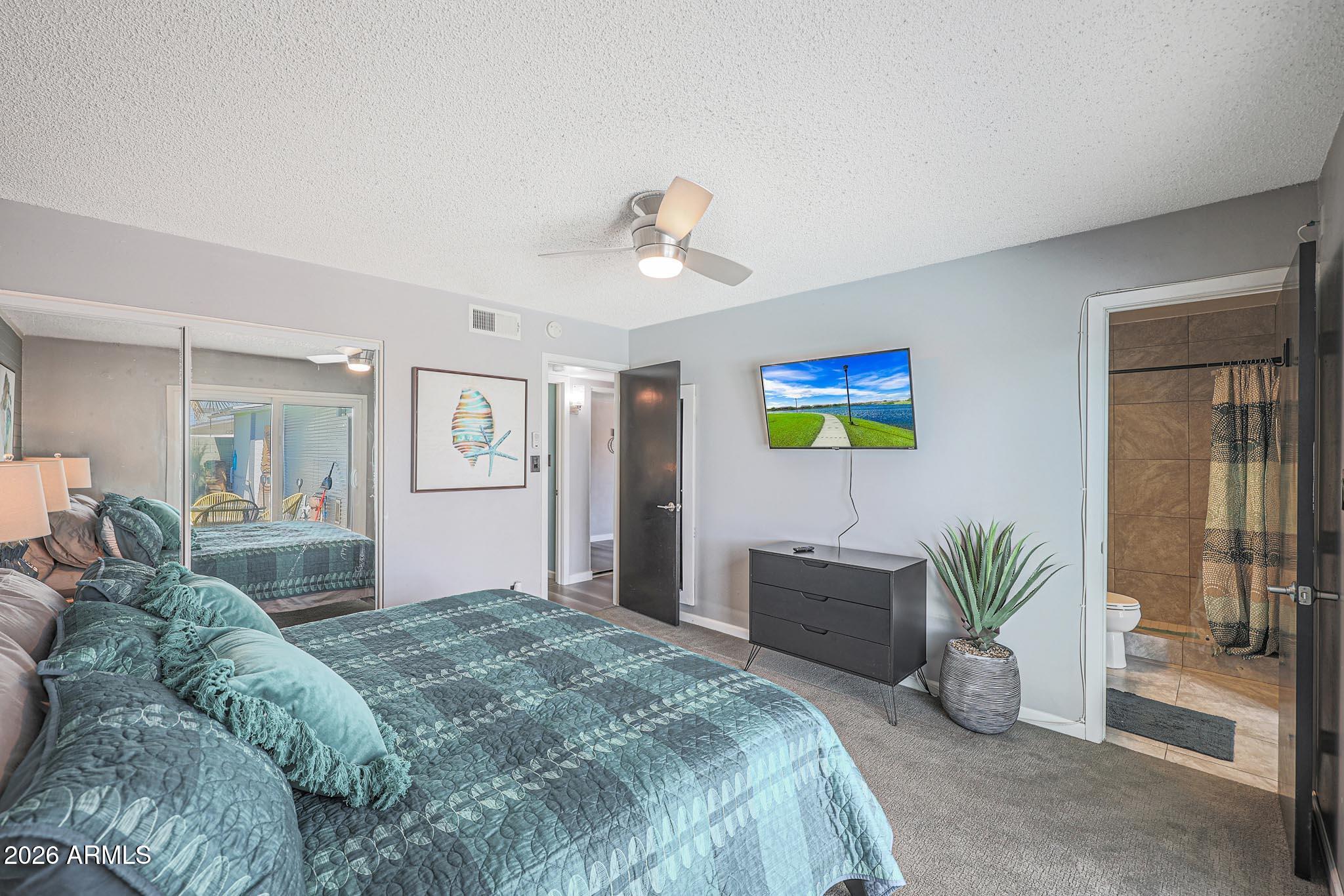 2201 East Marilyn Road Phoenix, AZ 85022 - Photo 30 of 47 a bedroom with a bed and ceiling fan