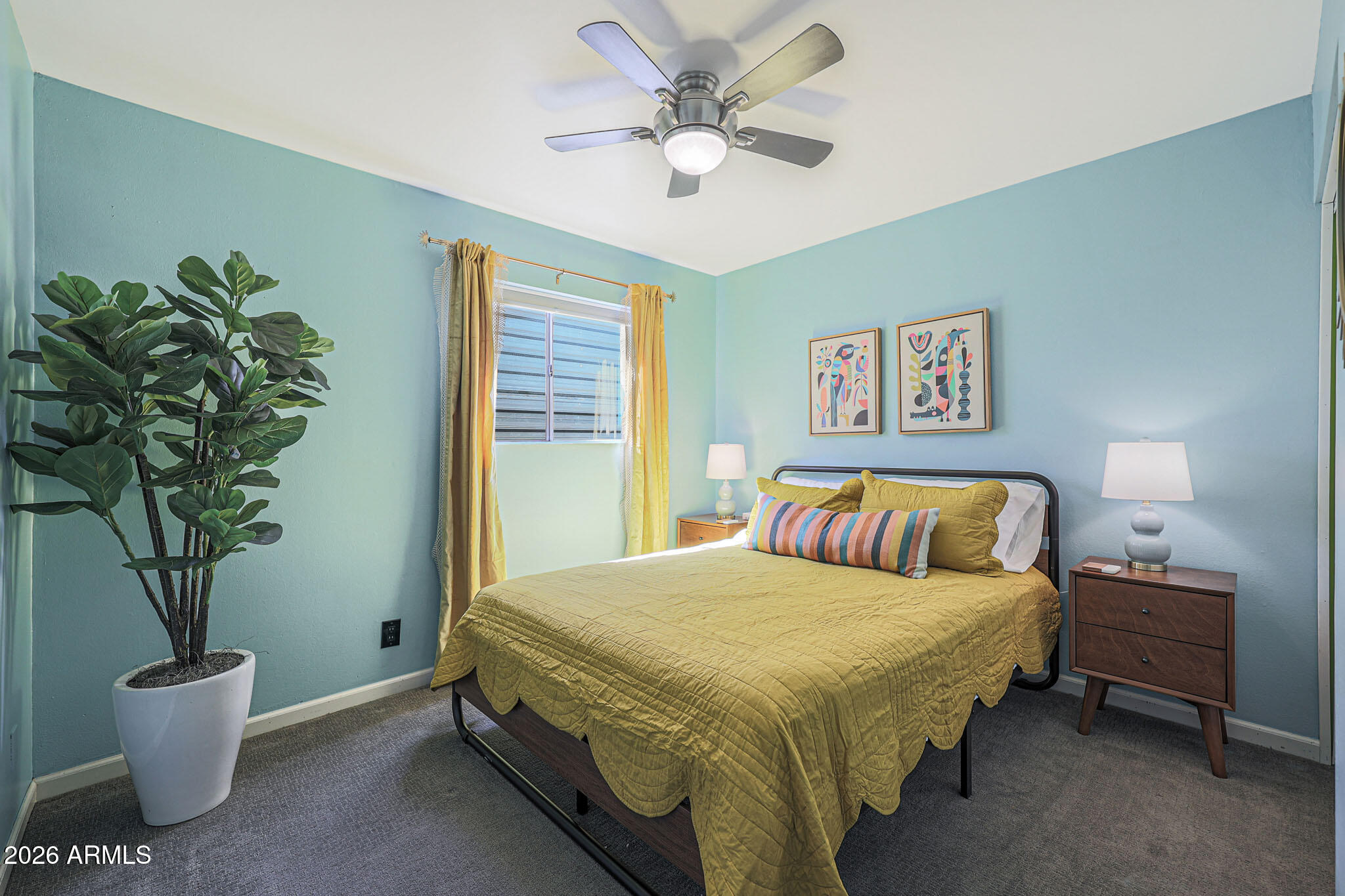 2201 East Marilyn Road Phoenix, AZ 85022 - Photo 32 of 47 a bedroom with a large bed and a potted plant