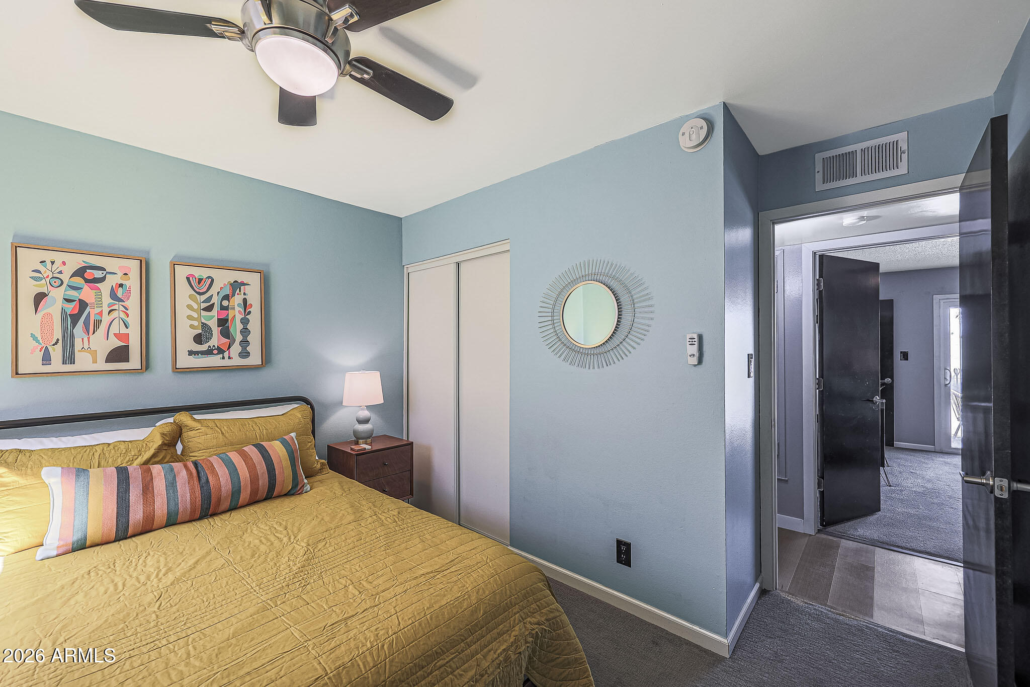 2201 East Marilyn Road Phoenix, AZ 85022 - Photo 33 of 47 a bedroom with a large bed and a chandelier